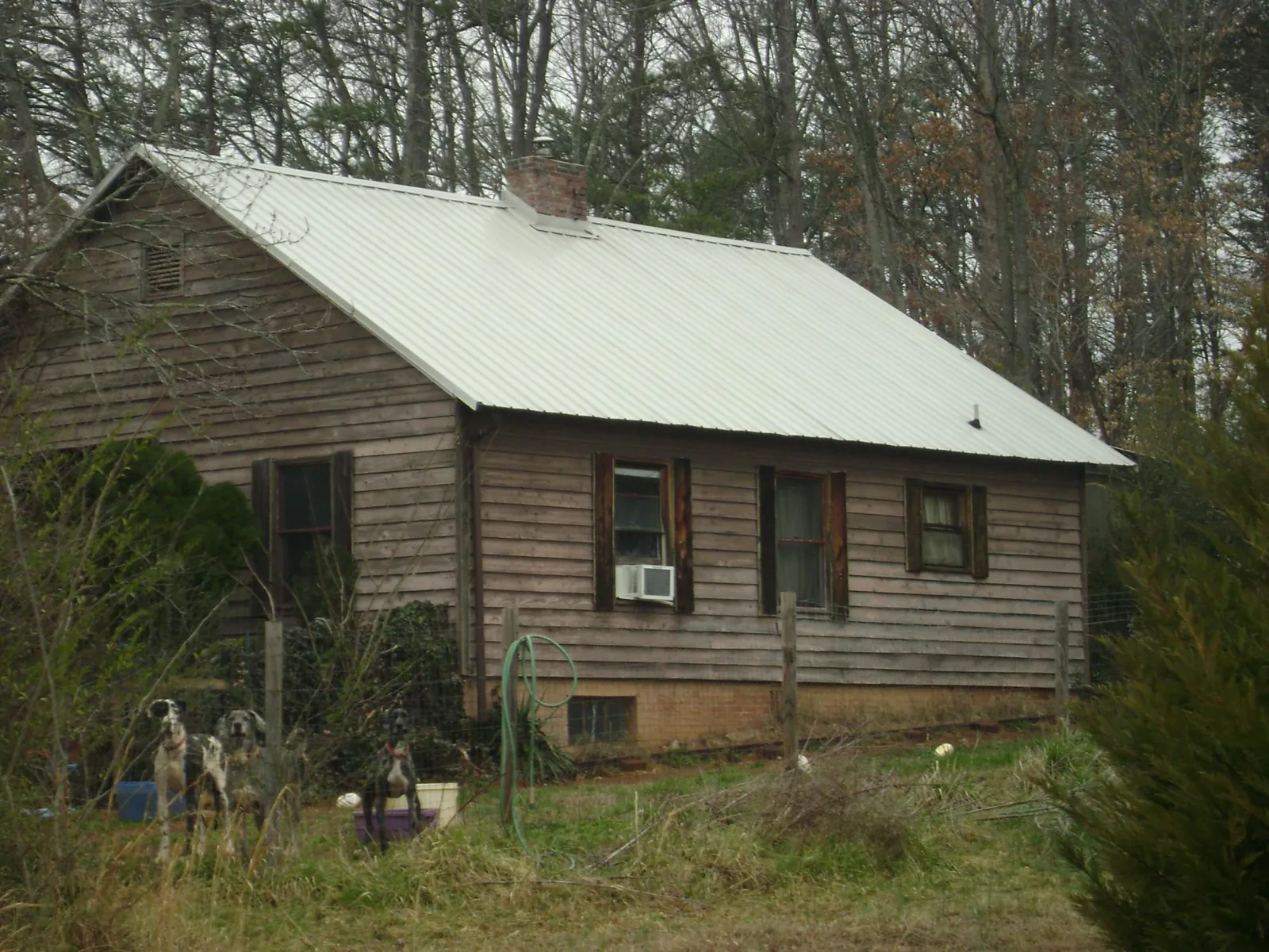 White metal roof on an old wood sided farmhouse, from a Metal Roof Installation job in Augusta